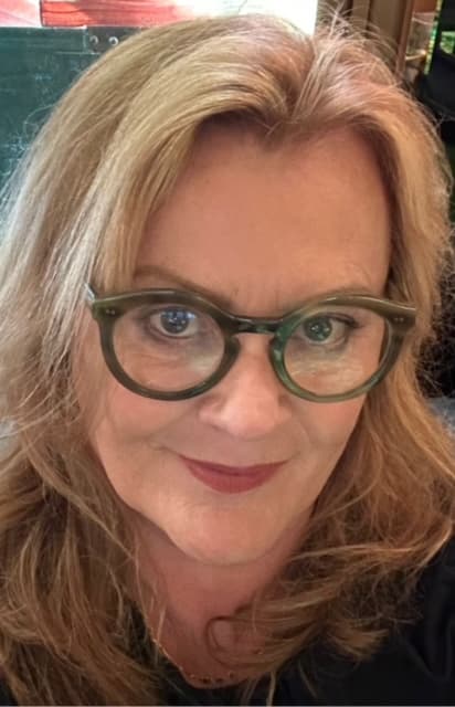 The author, in green tortoiseshell glasses.
